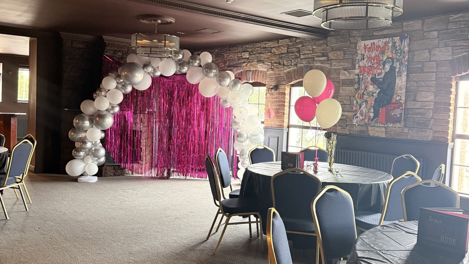 An event backdrop set up in the Function Room, ready for photos with guests