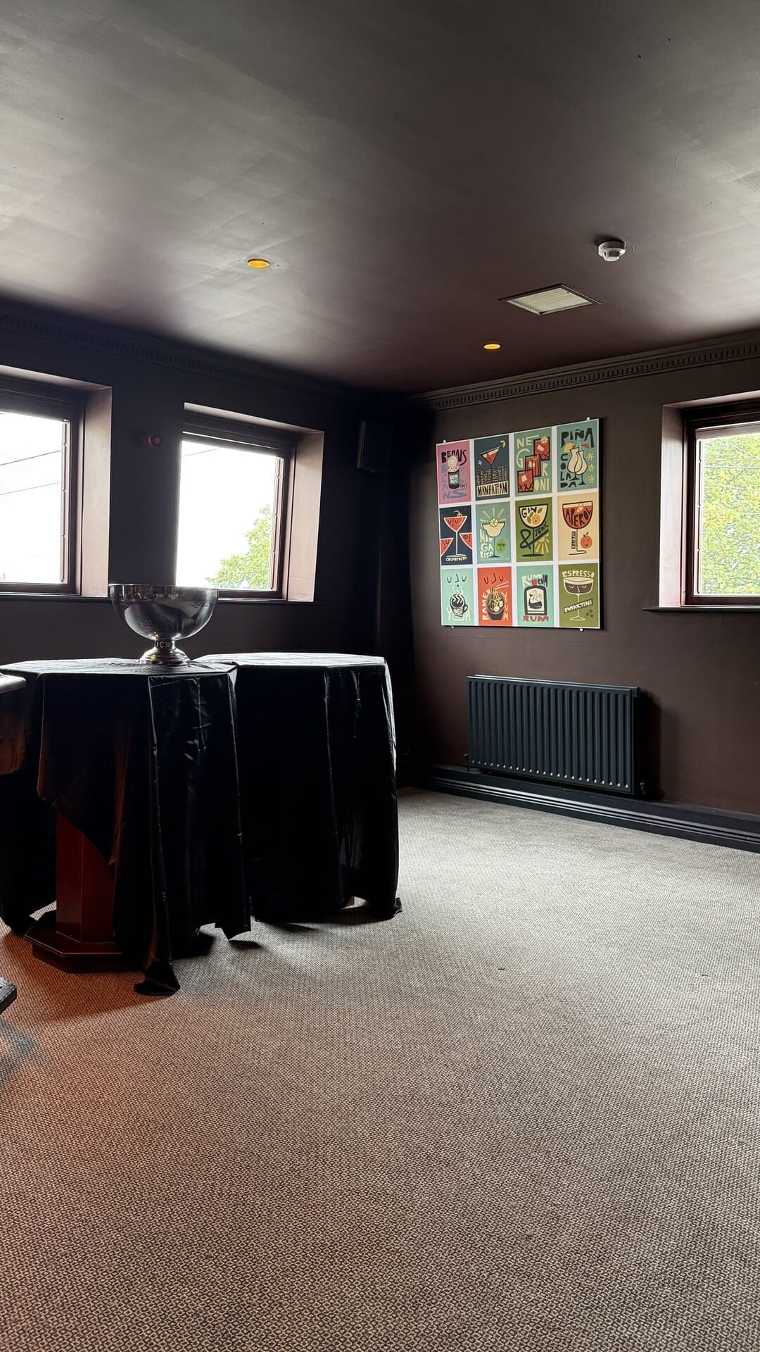 The open floor of the Function Room, with its tall windows and artwork