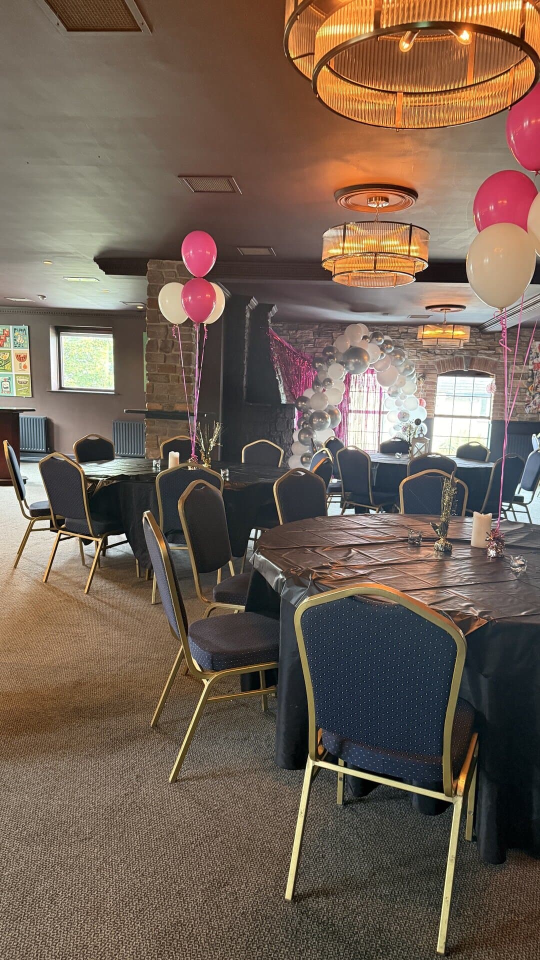 The Function Room set up for a birthday celebration, with balloons on every table
