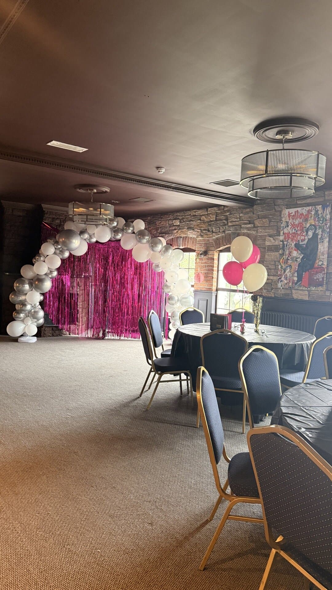 A balloon arch backdrop set up in the Function Room, ready for photos with guests